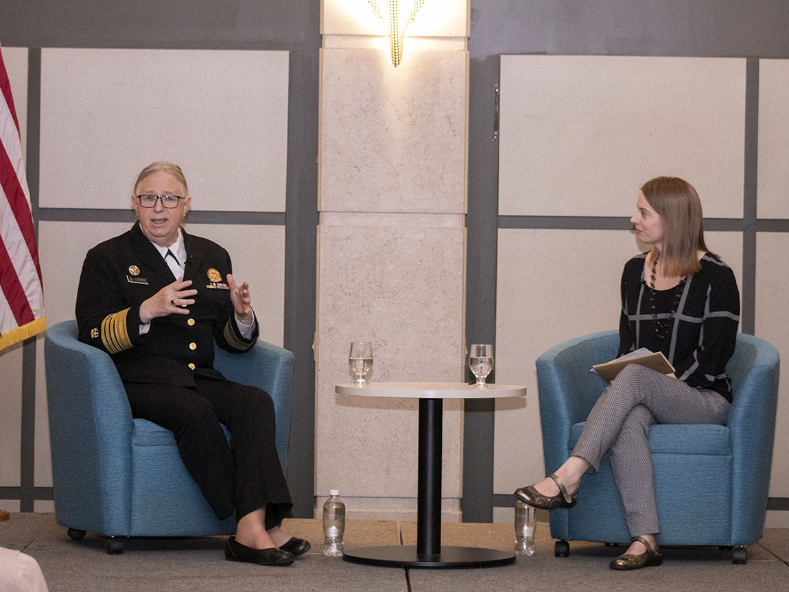 The U.S. Assistant Secretary for Health and a college professor converse on a stage